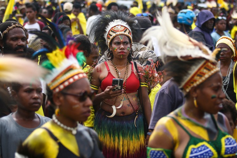 People in Timika in the troubled province of Papua at an election rally. Some are wearing traditional clothing