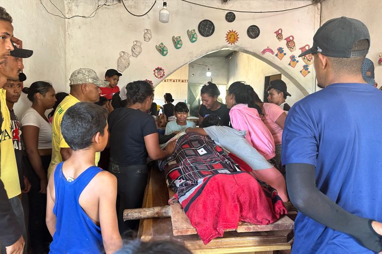 Relatives mourn one of the miners that died after the collapse of a remote illegal mine, in La Paragua, Bolivar state