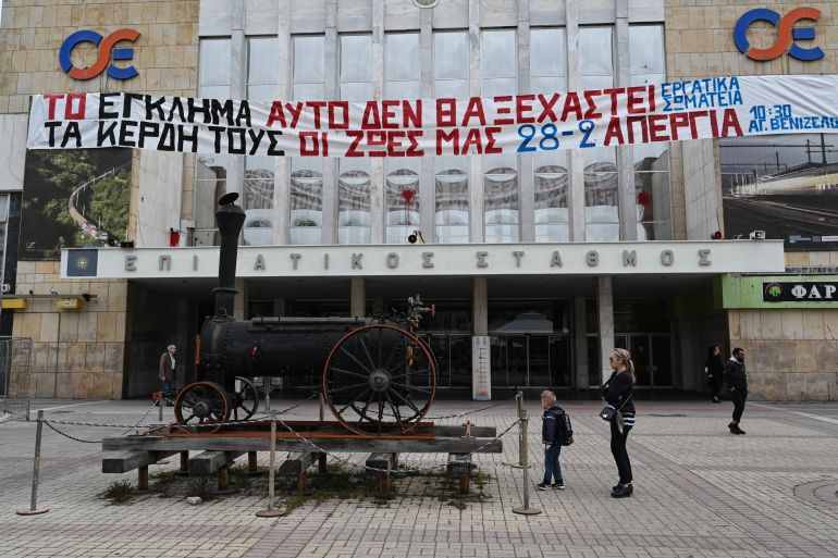 A banner reading "This crime will not be forgotten, their profits our lives" outside the central train station of Thessaloniki during a 24-hour strike on February 28, 2024