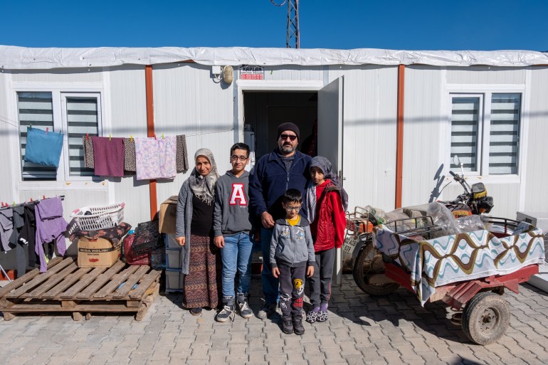 The family in front of their container home