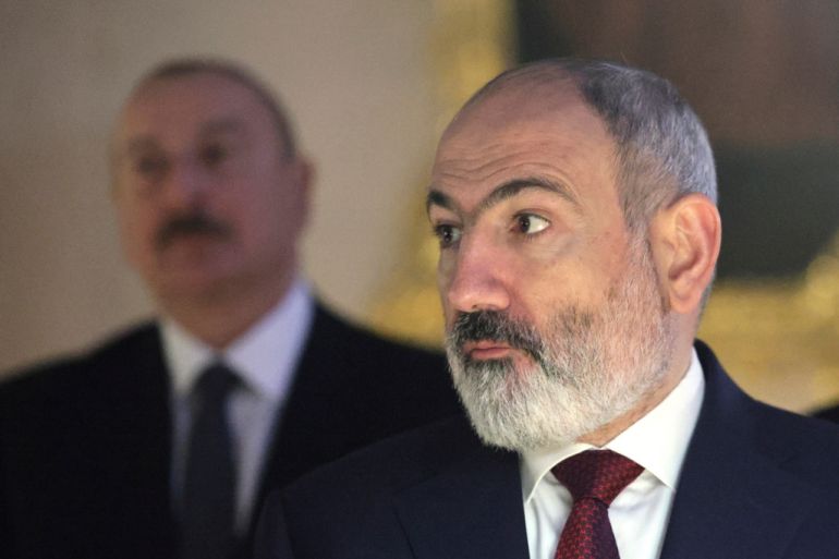 Armenian Prime Minister Nikol Pashinyan, right, and Azerbaijan's President Ilham Aliyev listen to a guide during a visit of CIS heads of state to the Catherine Palace on the sidelines of the Commonwealth of Independent States (CIS) heads of state meeting in St. Petersburg, Russia