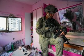 An Israeli soldier stands in an apartment during a ground operation in the Gaza Strip, Wednesday, Nov. 8, 2023 [AP Photo/Ohad Zwigenberg]