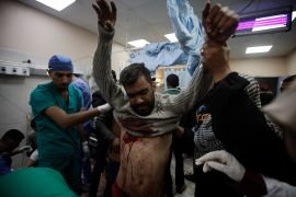 A Palestinian man wounded in the Israeli bombardment of the Gaza Strip receives treatment at the Nasser hospital in Khan Younis, Southern Gaza Strip, Monday, Jan. 22
