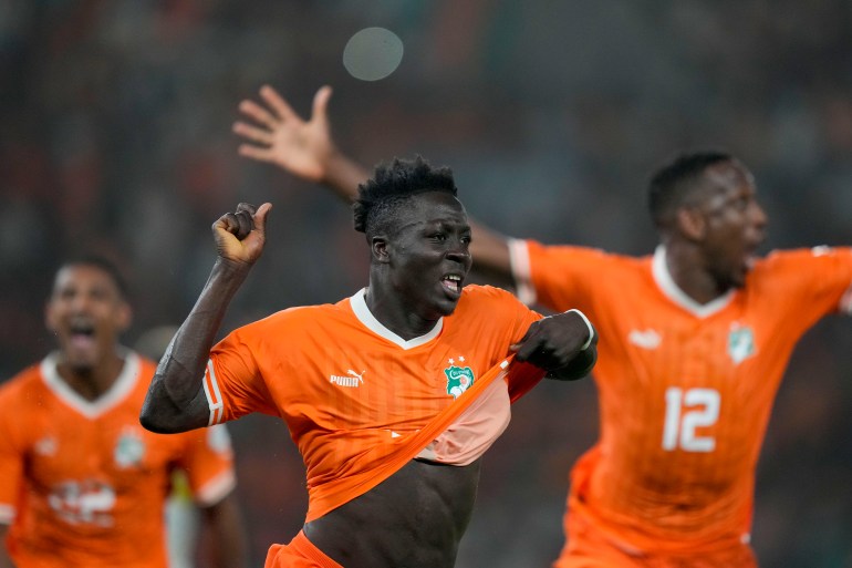 Ivory Coast 's Oumar Diakite, center, celebrates with teammates