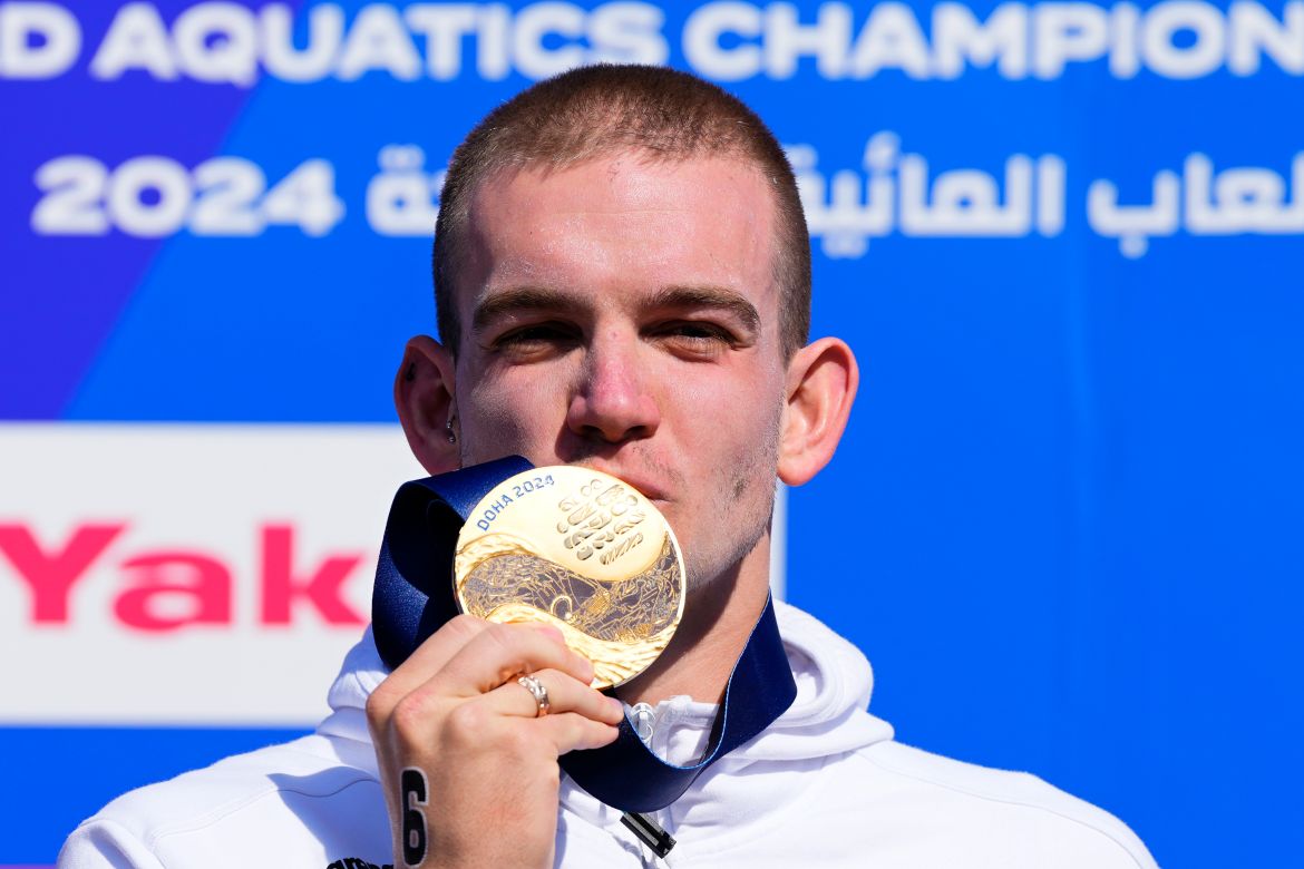 Kristof Rasovszky of Hungary poses on the podium after winning the men's 10 km open water final at the World Aquatics Championships in Doha, Qatar, Sunday, Feb. 4