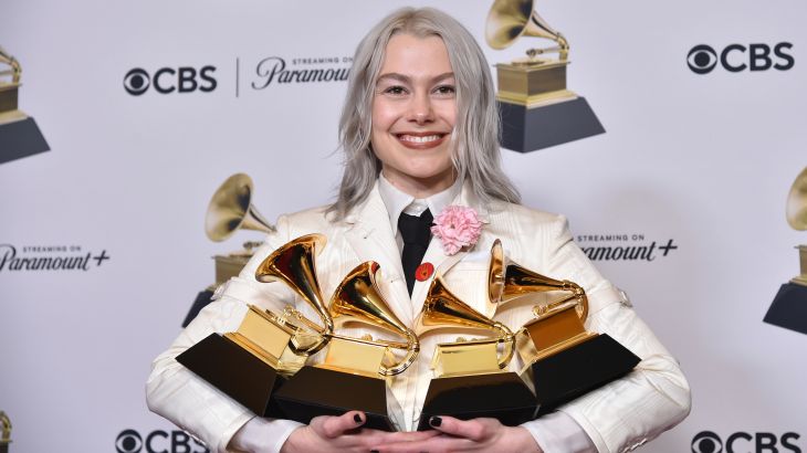 Phoebe Bridgers poses in the press room with the awards for best pop duo/group performance for "Ghost in the Machine," best rock song for "Not Strong Enough," best rock performance for "Not Strong Enough," and best alternative music album for "The Record" during the 66th annual Grammy Awards.