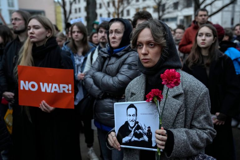 A woman holds a portrait of jailed Russian opposition leader Alexei Navalny during a protest in front of the Russian embassy in Berlin, Germany, Friday, Feb. 16