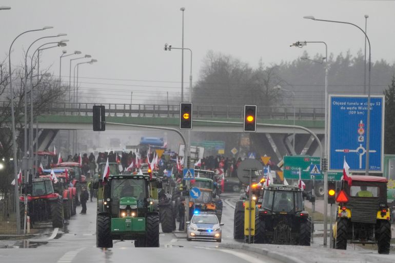 Polish farmers drive tractors in a convoy in Minsk Mazowiecki, Poland, on Tuesday Feb. 20, 2024, as they intensify a nationwide protest against the import of Ukrainian foods and European Union environmental policies. Farmers across Europe have been protesting recently, worried that EU plans to place limits on the use of chemicals and on greenhouse gas emissions will result in a reduction in production and income. They are also in revolt against competition from non-EU countries, in particular Ukraine. (AP Photo/Czarek Sokolowski)