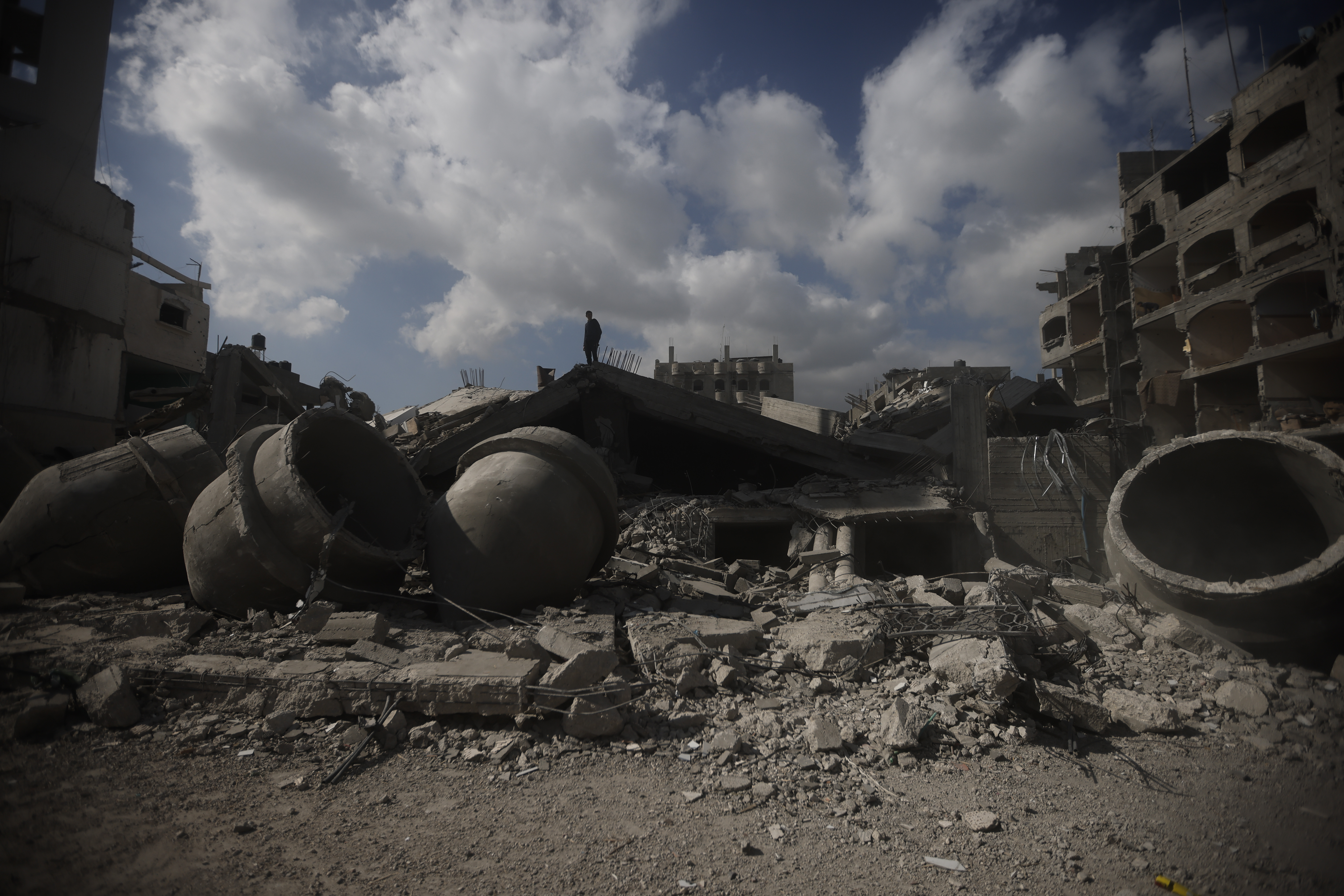 A Palestinian stands on top of a mosque destroyed in an Israeli strike in Rafah, Gaza Strip, Thursday, Feb. 22