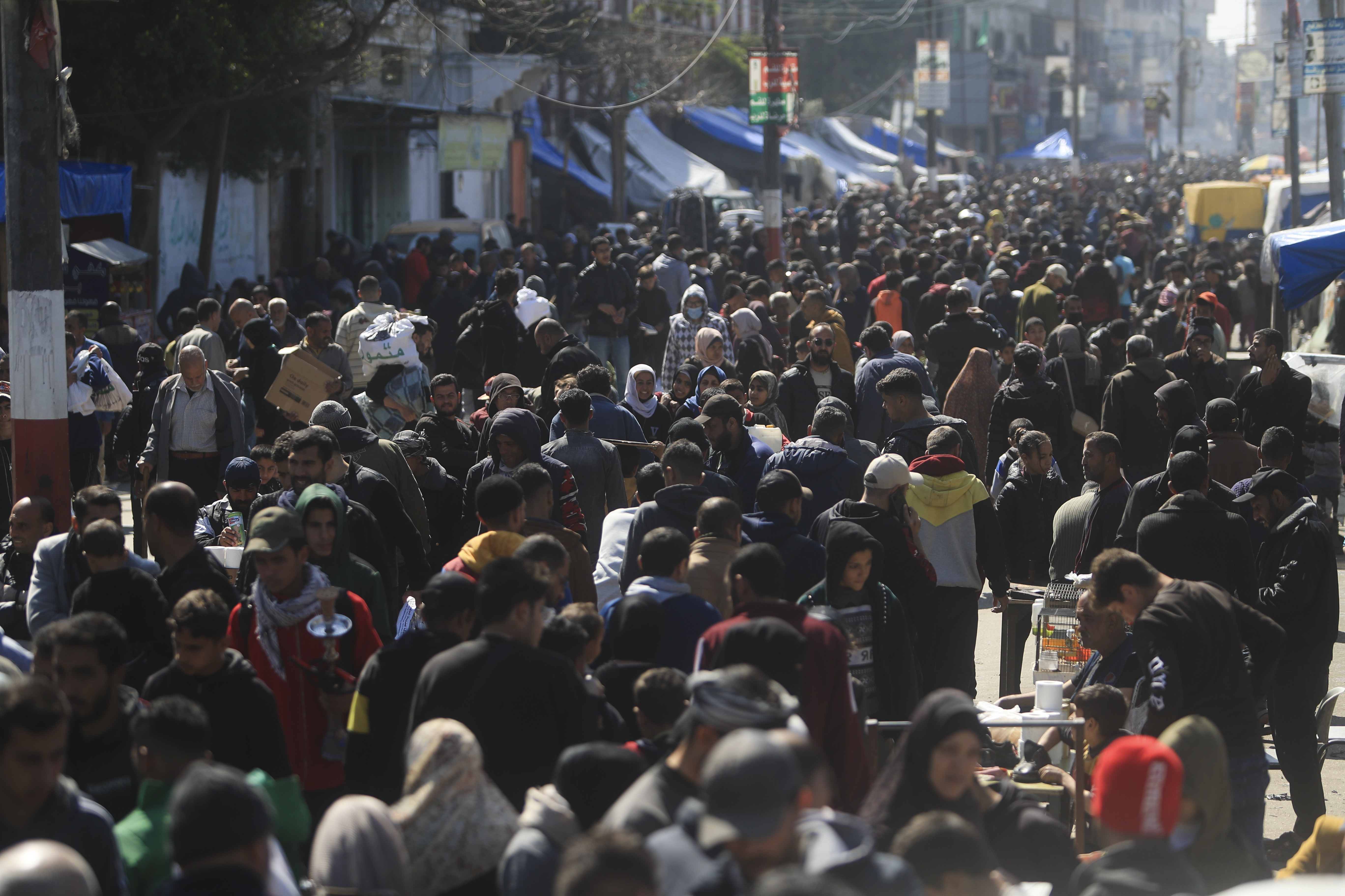 Palestinians crowd a market in Rafah, Gaza Strip, Thursday, Feb. 22