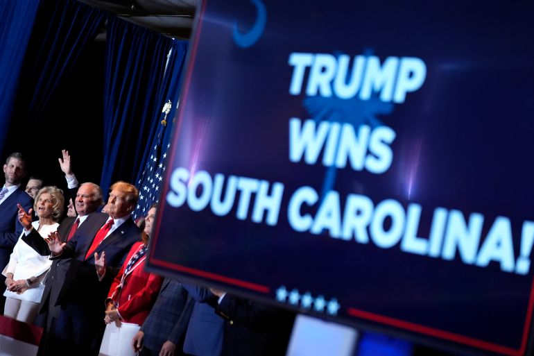 A sign reads "Trump wins South Carolina."