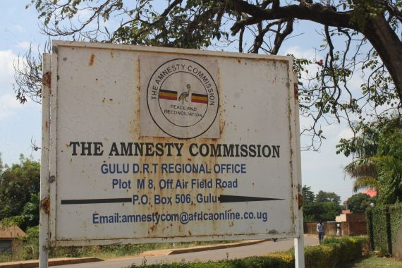 A rusty and faded sign for the Amnesty Commision, which once helped facilitate the return of former members of the LRA is seen in Gulu, northern Uganda.