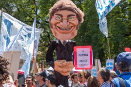 Protesters in Argentina carry aloft an effigy of President Javier Milei