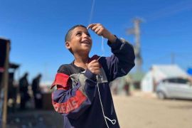Tariq Khalaf had the sticks but not the paper to make a kite, so he made a deal so he could have a kite [Ruwaida Amer/Al Jazeera]