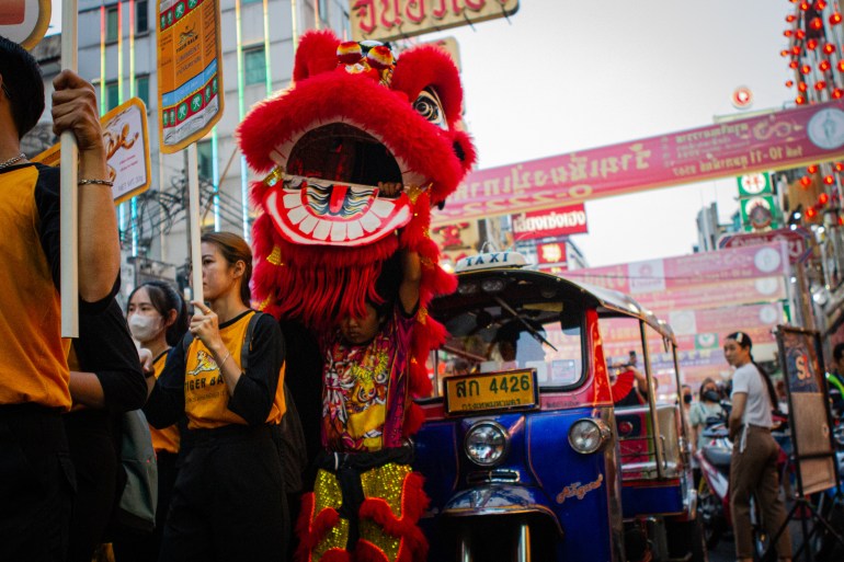 Lion dance in Bangkok. The lion is red