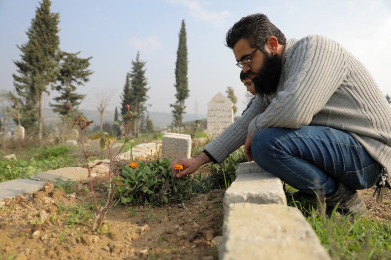 Ibrahim crouching at the side of a grave