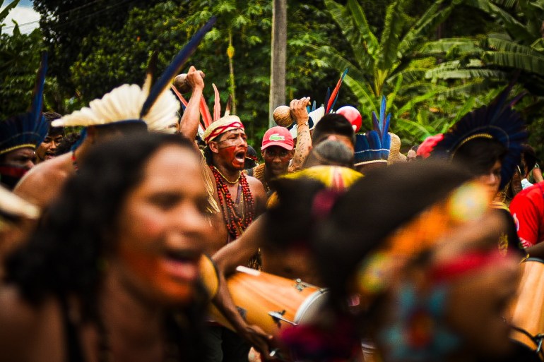 A crowd of Indigenous land defenders, including Mukunã Pataxó, protests in Brazil