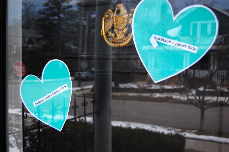 Turquoise hearts with the phrase, 'Neighbors Stand Against Hate', on the front door to Rich Price's house in Burlington, Vermont, US