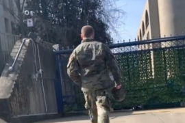 Aaron Bushnell walking towards the gate of the Israeli embassy [Screengrab/Al Jazeera]