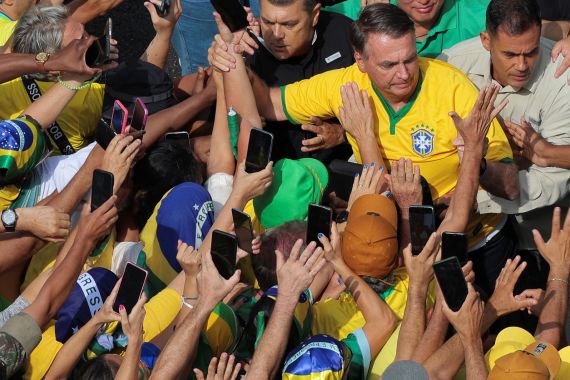 Pro-Bolsonaro supporters gather with Jair Bolsonaro.