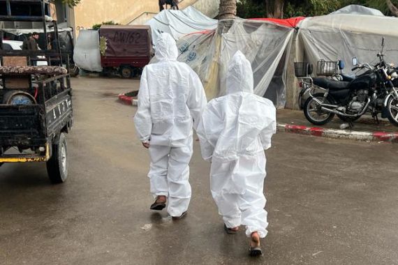 Medical coveralls for warmth in Gaza