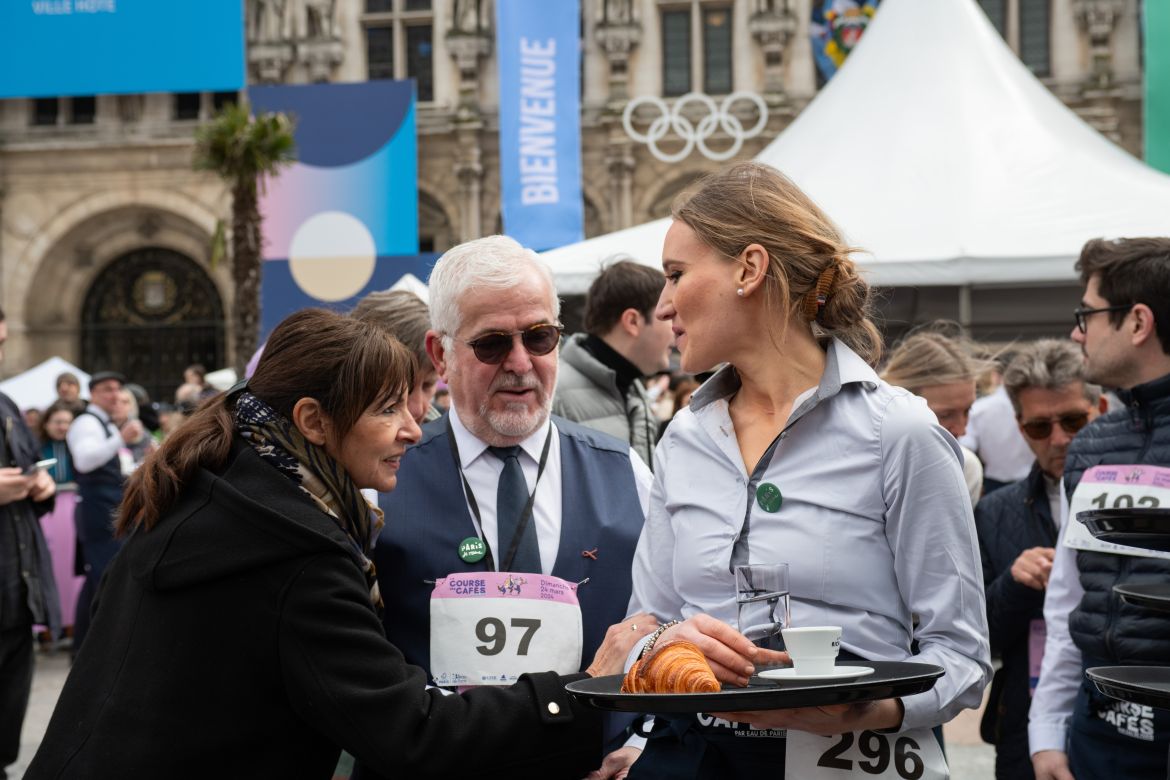 Paris Mayor Anne Hidalgo congratulates Pauline Van Wymeersch of Cafe le Petit Pont, located in the 5th arrondissement, on finishing first among female competitors.