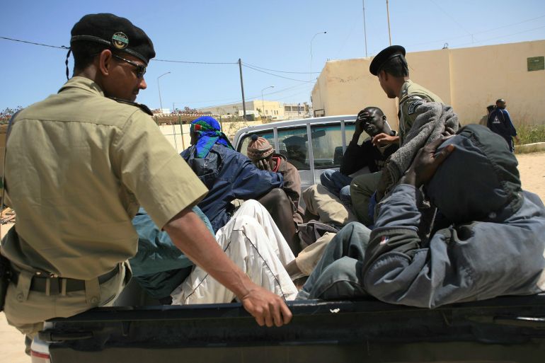 Would-be immigrants are transported in a car by Mauritanian police officials in Nouadhibou before being expelled from the country May 23, 2006. As Spain has improved cooperation with Morocco and Mauritania to close down clandestine migration routes, both on land and sea, would-be migrants have been setting off from further and further down the West African coast. REUTERS/Juan Medina