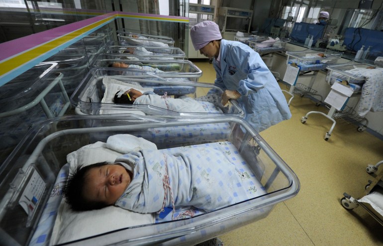 A nurse takes care of newborn babies at a hospital in Hefei, Anhui province April 21, 2011. China's mainland population grew to 1.339 billion by 2010, according to census figures released on Thursday, up 5.9 percent from the 1.265 billion at the last census in 2000, and lower than the 1.4 billion population some demographers had projected for the latest count. Picture taken April 21, 2011. REUTERS/Stringer (CHINA - Tags: HEALTH SOCIETY)