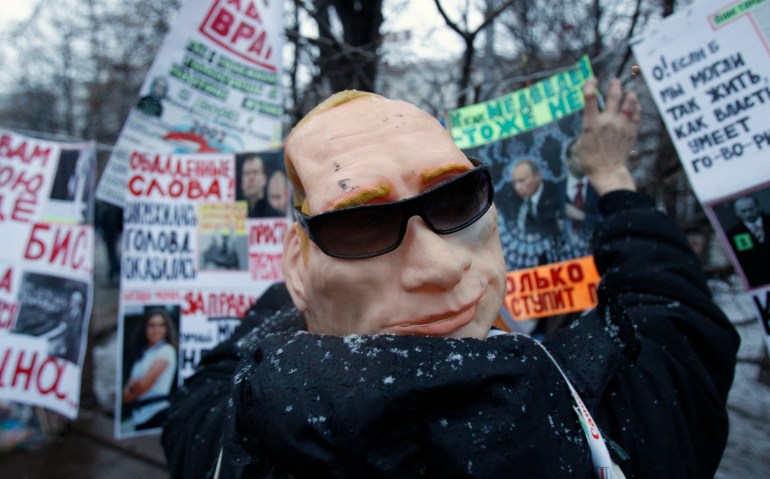 A protester, who is wearing a mask of Russia's Prime Minister Vladimir Putin, attends a sanctioned rally in Bolotnaya square to protest against violations at the parliamentary elections in Moscow December 10, 2011. Tens of thousands of protesters took to the streets of cities across Russia on Saturday to demand an end to Vladimir Putin's rule and complain about alleged election fraud in the biggest show of defiance since he took power more than a decade ago. REUTERS/Sergei Karpukhin (RUSSIA - Tags: POLITICS ELECTIONS CIVIL UNREST)