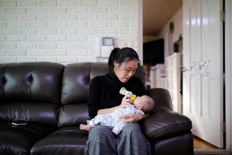 Kim Mi-sung feeds her baby son at their home in Seoul, South Korea.