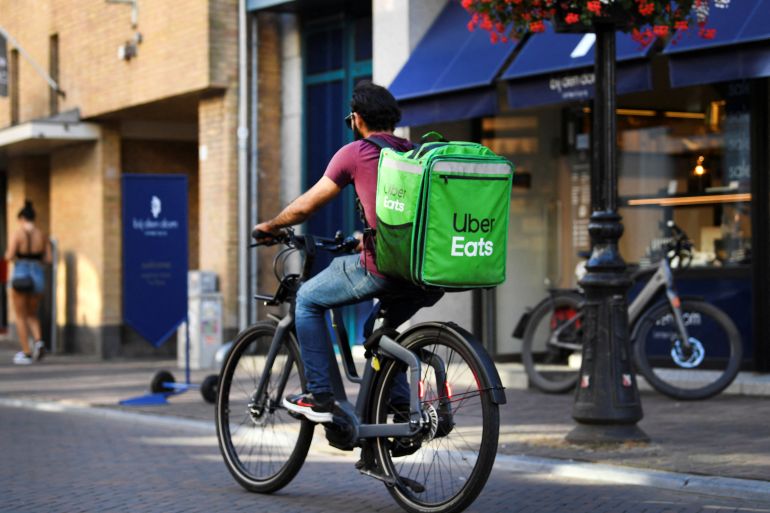 A bicycle courier from Uber Eats rides his bicycle during the heatwave in Utrecht, Netherlands