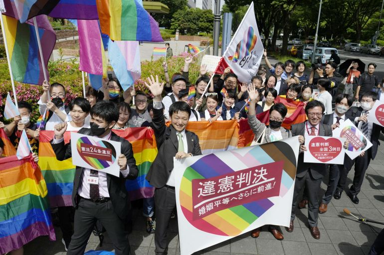 People hold banners at a LGBTQ rally in Japan