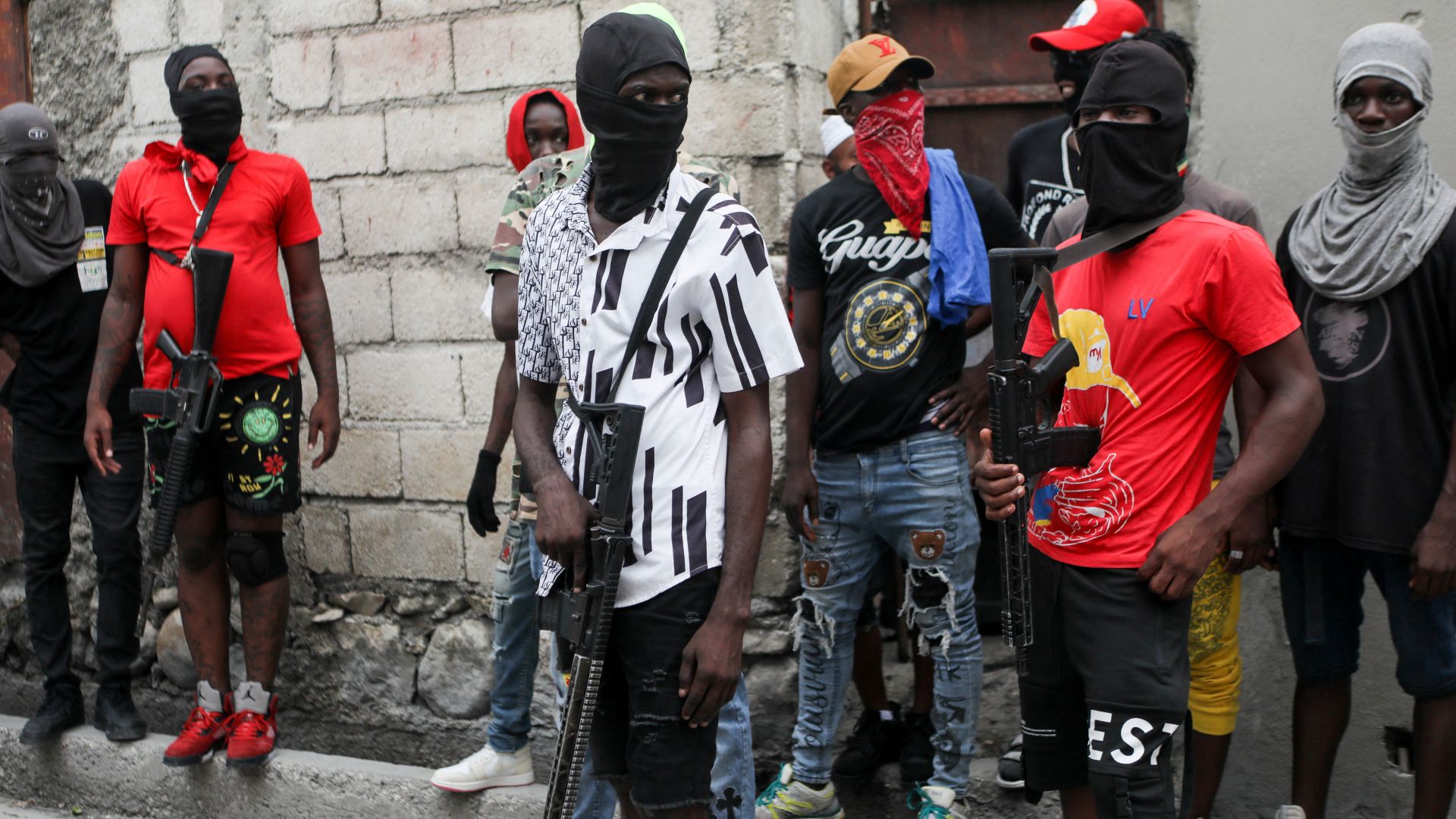 Haitian gang members provide security to Jimmy 'Barbecue' Cherizier, head of the G9 gang coalition, in Port-au-Prince