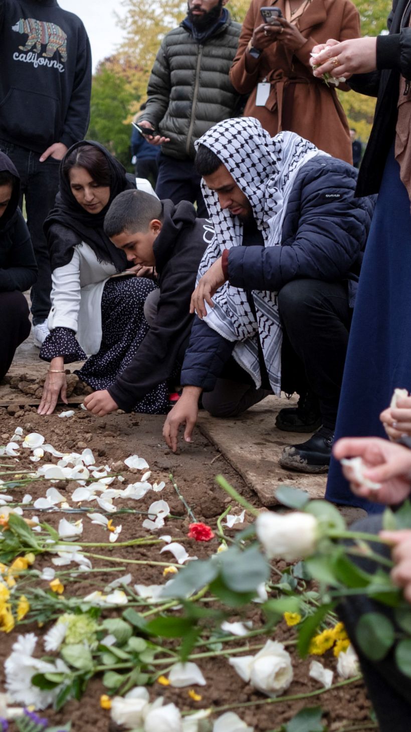 Mourners place flowers at the grave of Wadea Al-Fayoume, a six-year-old Palestinian American child, who was killed in a Chicago suburb