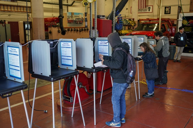 People filling out ballots in booths