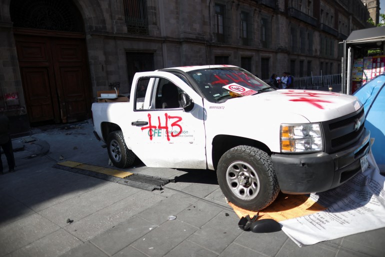 Graffiti displayed on a vehicle used to ram a door to Mexico's presidential palace