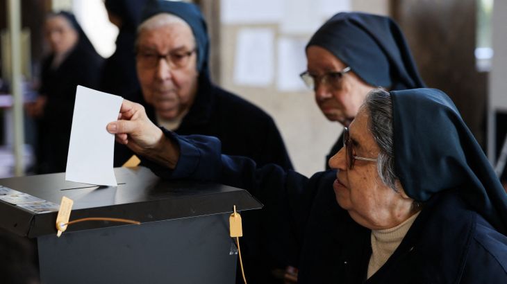 A nun casts her ballot at a polling station during the general election in Lisbon, Portugal