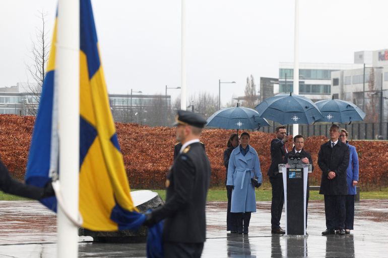 Swedish Prime Minister Ulf Kristersson, NATO Secretary General Jens Stoltenberg and Sweden's Crown Princess Victoria attend a flag-raising ceremony at NATO headquarters following the accession of Sweden to the alliance, in Brussels [Yves Herman/Reuters]