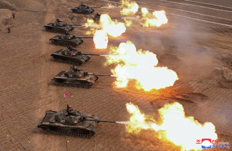 North Korean leader Kim Jong Un guides a military demonstration involving tank units