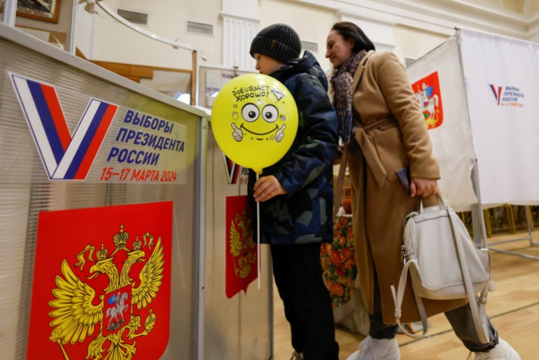 People vote at a polling station during the presidential election in Vidnoye, Moscow Region