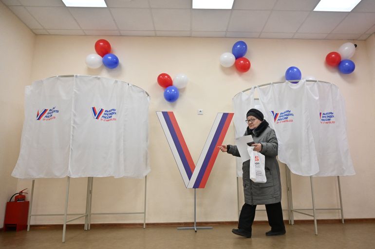 A woman walks to cast her ballot at a polling station during the presidential election in Rostov-on-Don, Russia