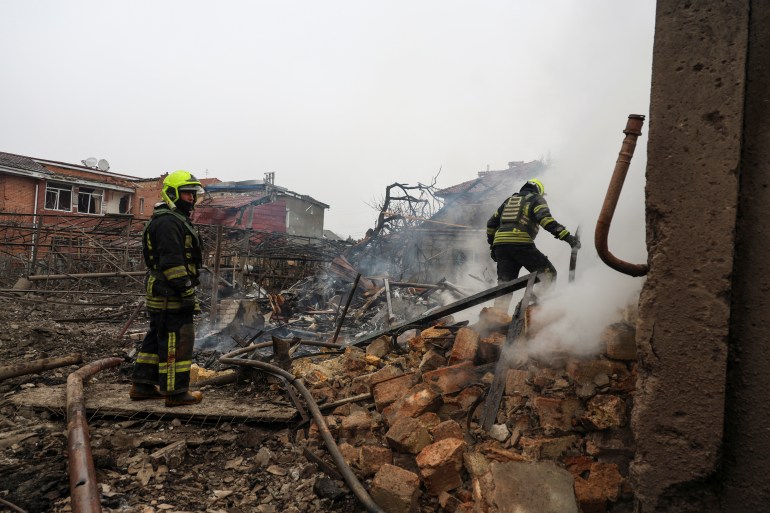 Rescuers work at the site of a residential area hit by a Russian missile strike
