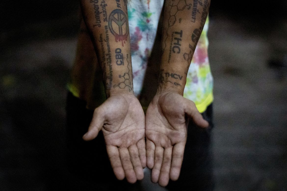 Aof Rugun shows his cannabis-related tattoos, during a party in Bangkok