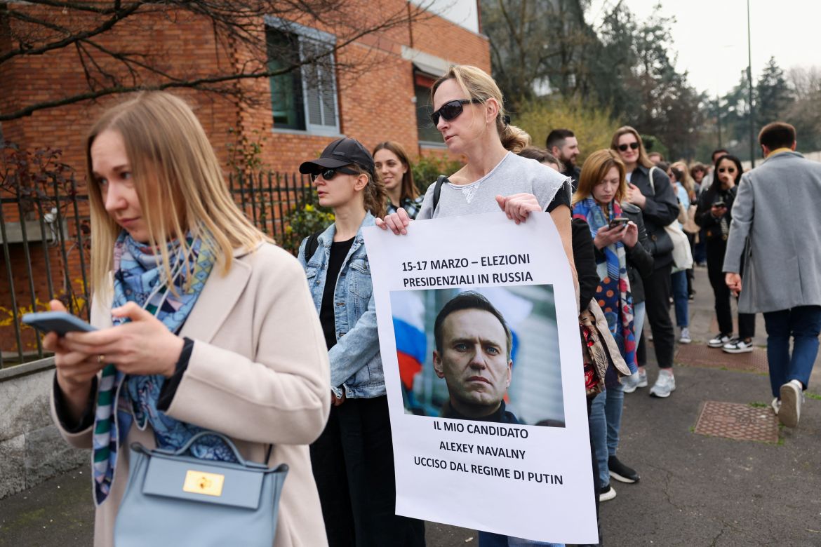 A woman holds a placard with a photo of late Russian opposition leader Alexei Navalny outside the Russian Consulate, on the final day of the presidential election in Russia, amid Russia's attack on Ukraine, in Milan