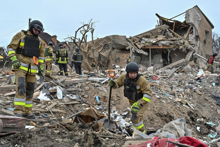 Rescue members work at a site of residential buildings destroyed by a Russian missile strike, amid Russia's attack on Ukraine, in Zaporizhzhia, Ukraine, on March 22, 2024