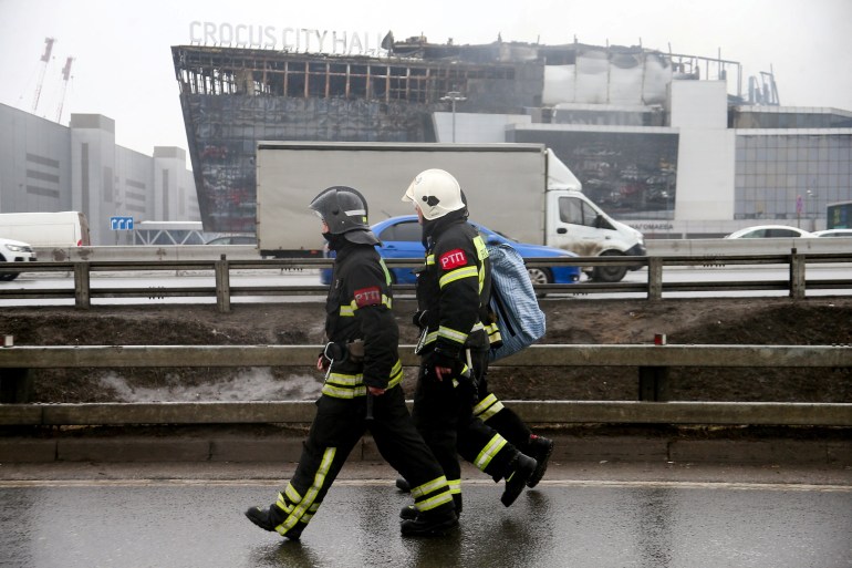 Firefighters walk near the Crocus City Hall concert venue following Friday's deadly attack, outside Moscow, Russia, March 23, 2024. Sergei Vedyashkin/Moscow News Agency/Handout via REUTERS ATTENTION EDITORS - THIS IMAGE HAS BEEN SUPPLIED BY A THIRD PARTY. MANDATORY CREDIT.
