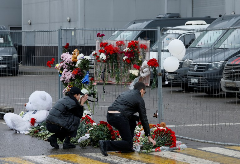 People lay flowers at a makeshift memorial to the victims of a shooting attack at the Crocus City Hall concert venue in the Moscow Region, Russia, March 23
