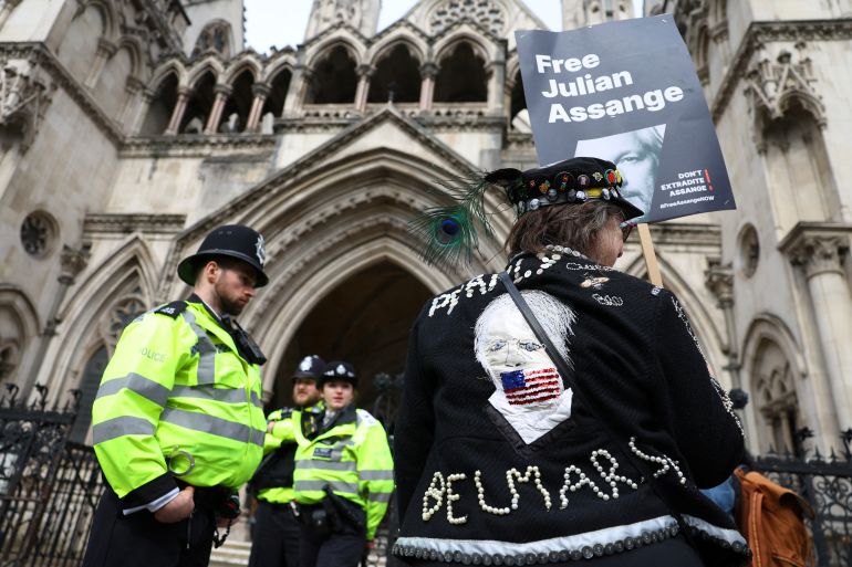 A supporter of WikiLeaks founder Julian Assange holds a sign, following a ruling on whether Julian Assange can appeal against extradition from Britain to the United States, in London, Britain, March 26, 2024. REUTERS/Toby Melville