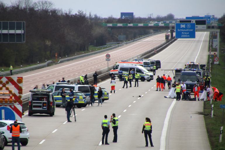 Emergency staff talk at the scene after several people were killed and more injured in a coach crash on the A9 motorway off Schkeuditz, near the eastern German