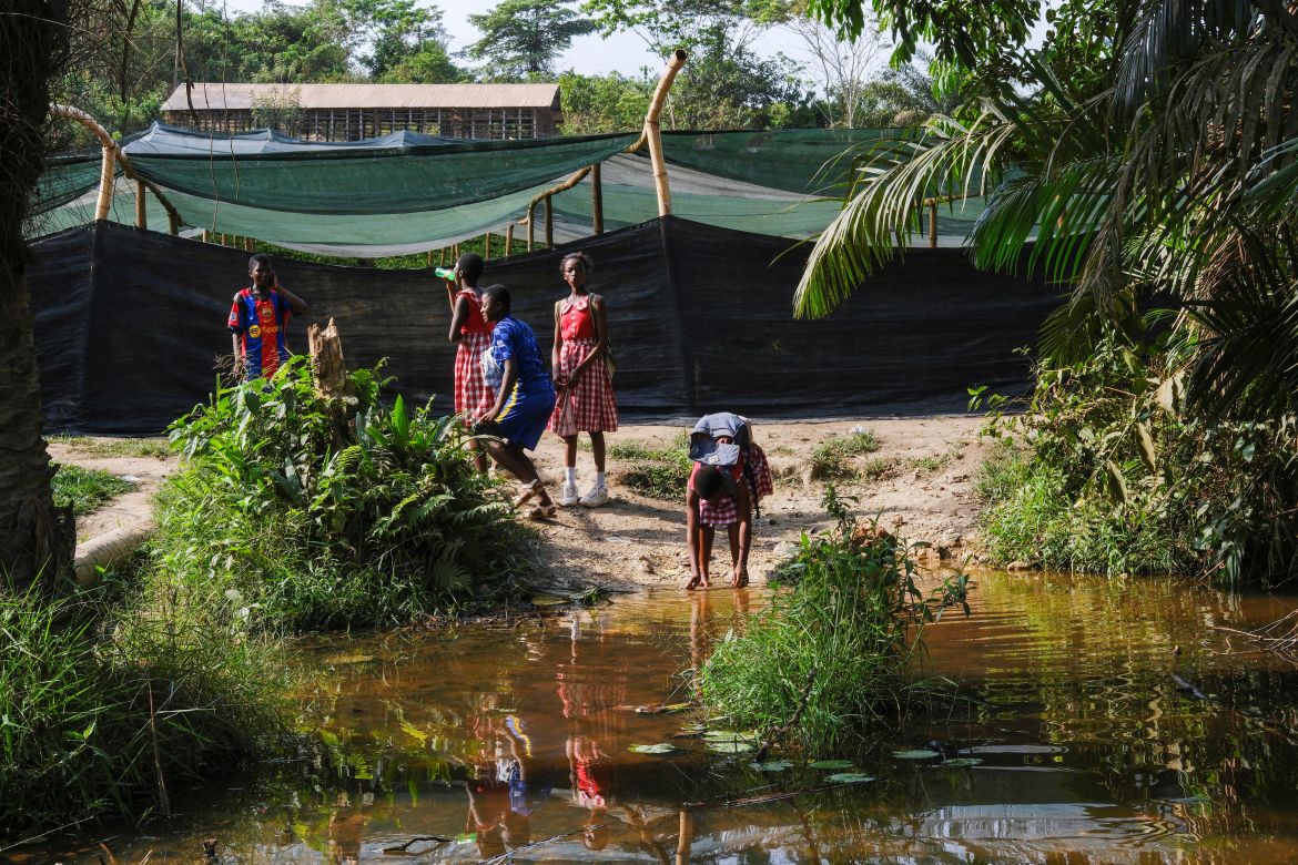 Schoolchildren drink from a pond in the Samreboi community in the Western Region, Ghana